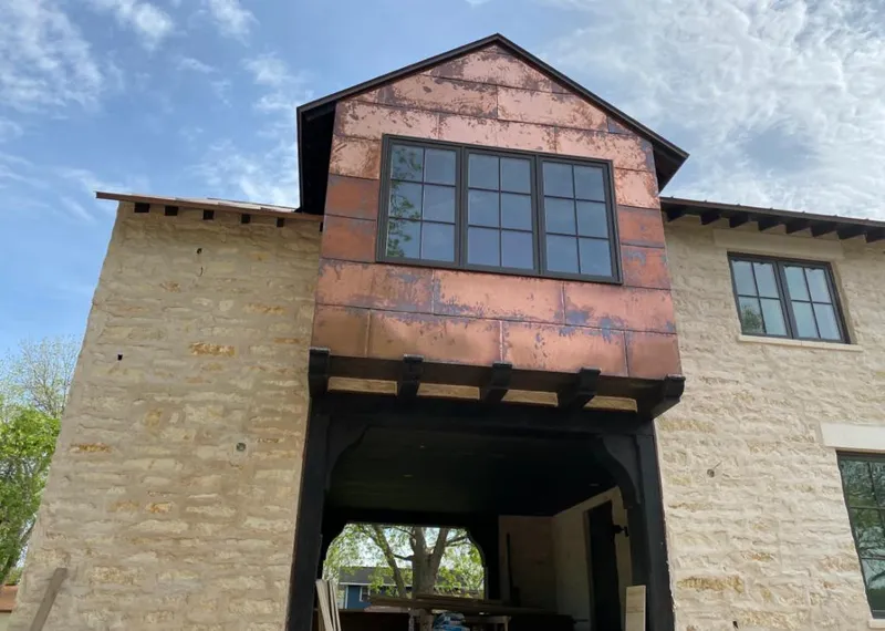 Copper metal panel facade on a stone building for Skylight Installation in Northville