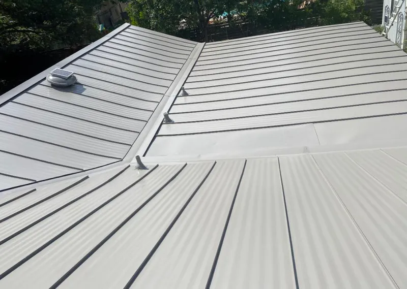 Solar attic fan installed on a metal roof for Roof Ventilation in Northville